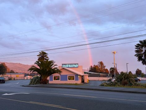 Superfly Martini Bar & Grill in Brookings, Oregon, with a rainbow over the building